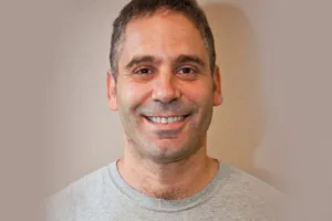 Ido, Founder of Swift Restoration, smiling in a professional setting.